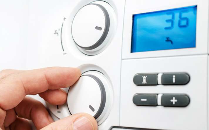 Professional plumbing tools including copper fittings, wrench and pipe cutter arranged neatly - SC Plumbing & Heating services